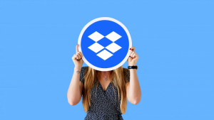woman holding the sign of dropbox with blue background